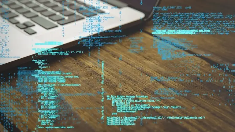digital composite of laptop with hacking graphic